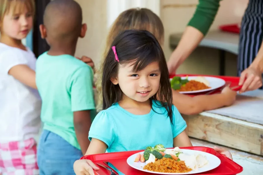 Girl with school lunch tray