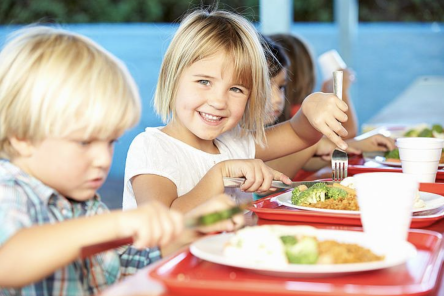young girl at table with lunch