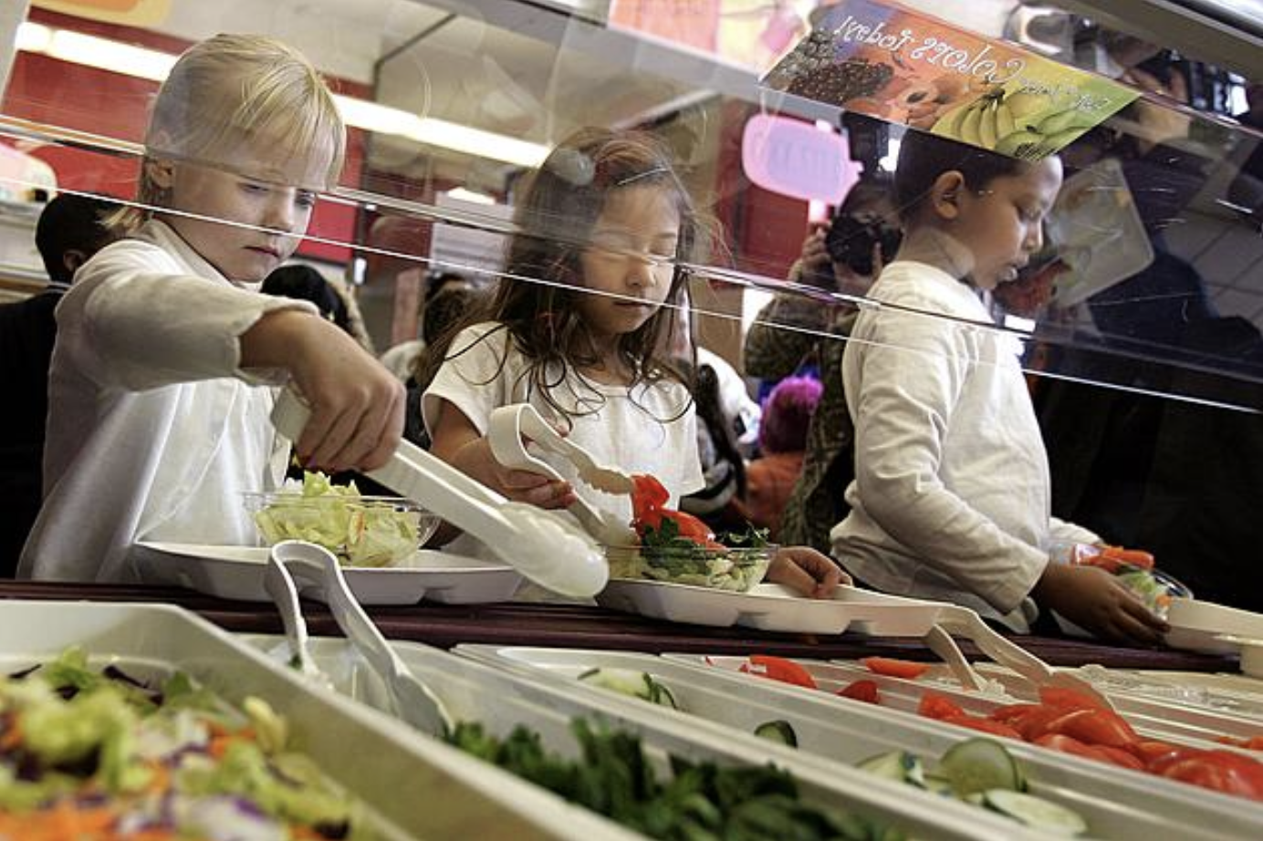 students getting school lunch in cafeteria