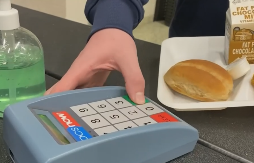 student using pin pad to purchase school lunch