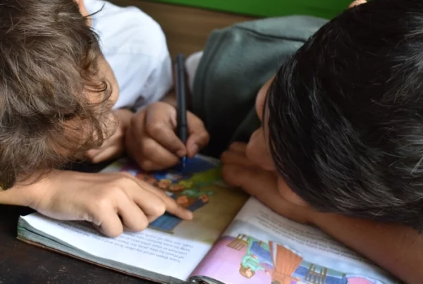 students reading book together